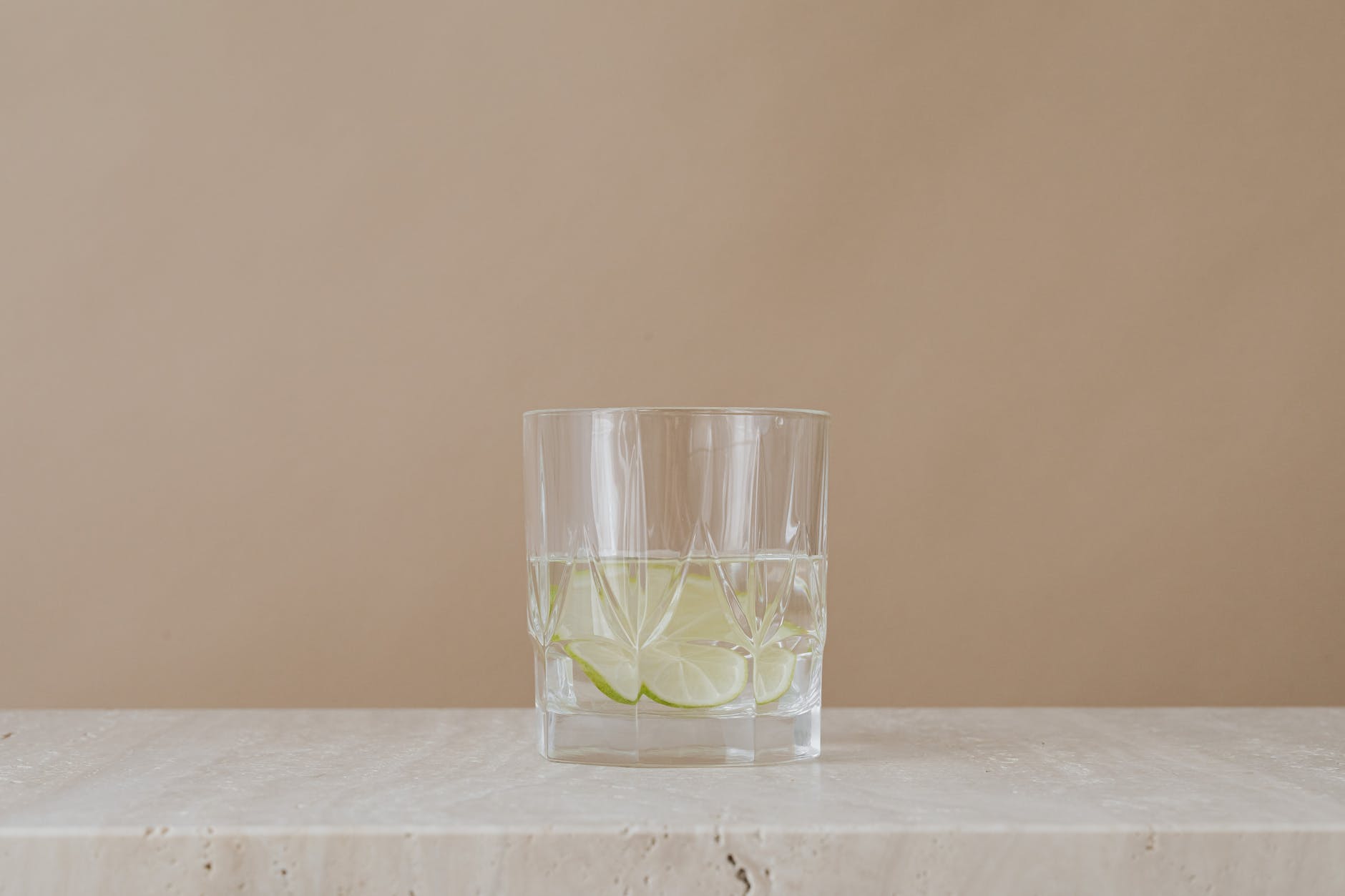 clear drinking glass with water and lime
